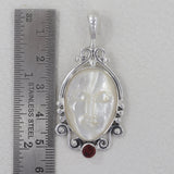 Face Carved Mother of Pearl With Garnet Silver Pendant